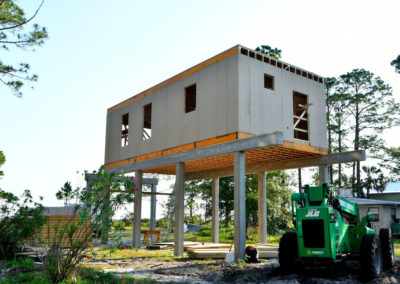 SIPs beach house elevated on piers during construction.