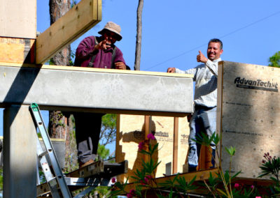 Construction crew giving thumbs-up on site.