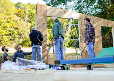 Building crew at job site setting panels.