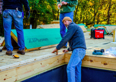 Builder setting bottom plate on subfloor.